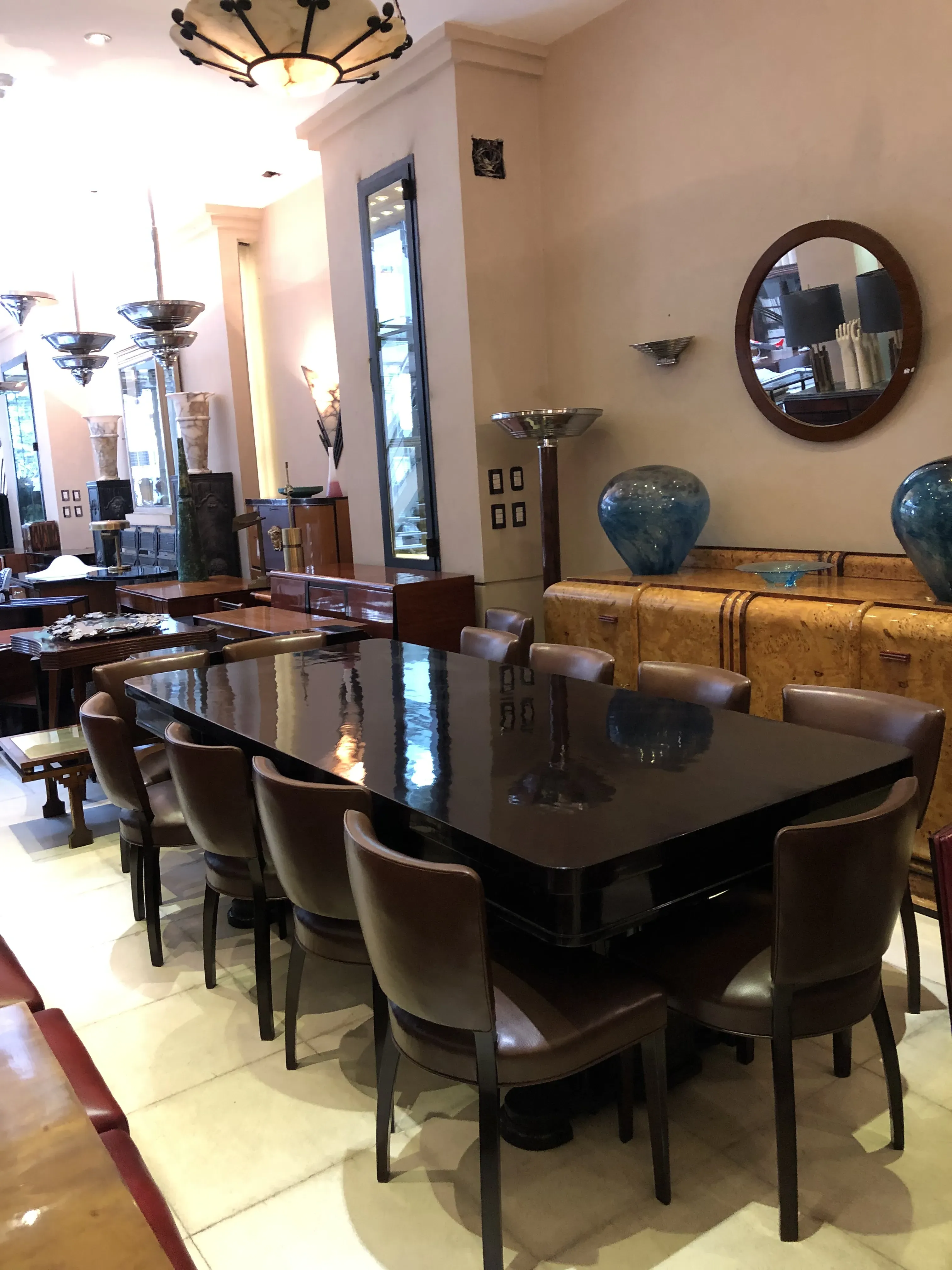 Antique dining table with chairs in an elegant setting.