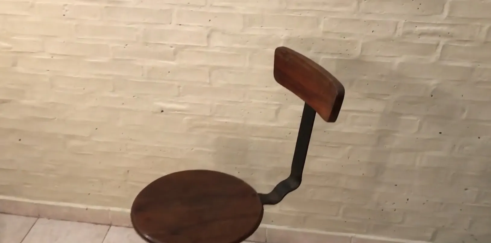 Antique brown chair with backrest, set in a neutral environment.