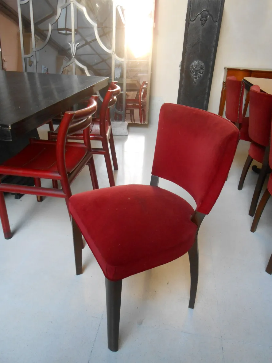10 antique red chairs ready for restoration, cozy environment.