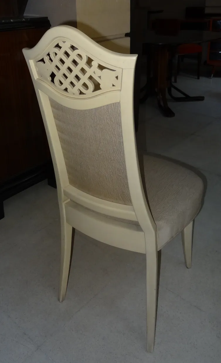 12 antique chairs with classic design, used, in a rustic setting.