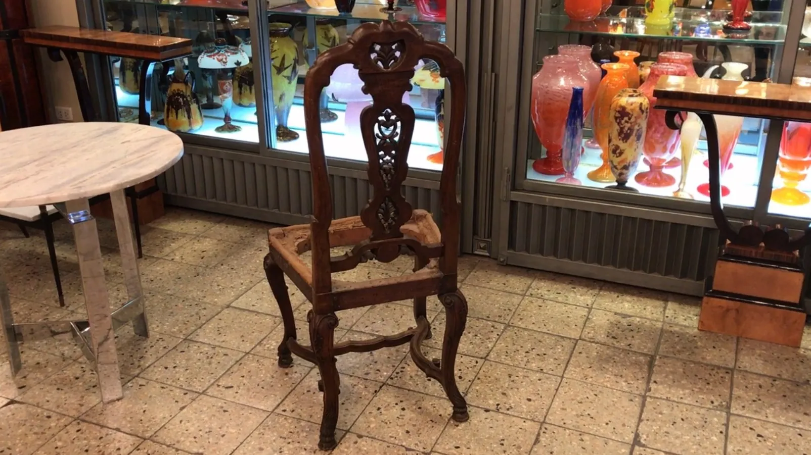 antique chair with detailed design, in an antique setting