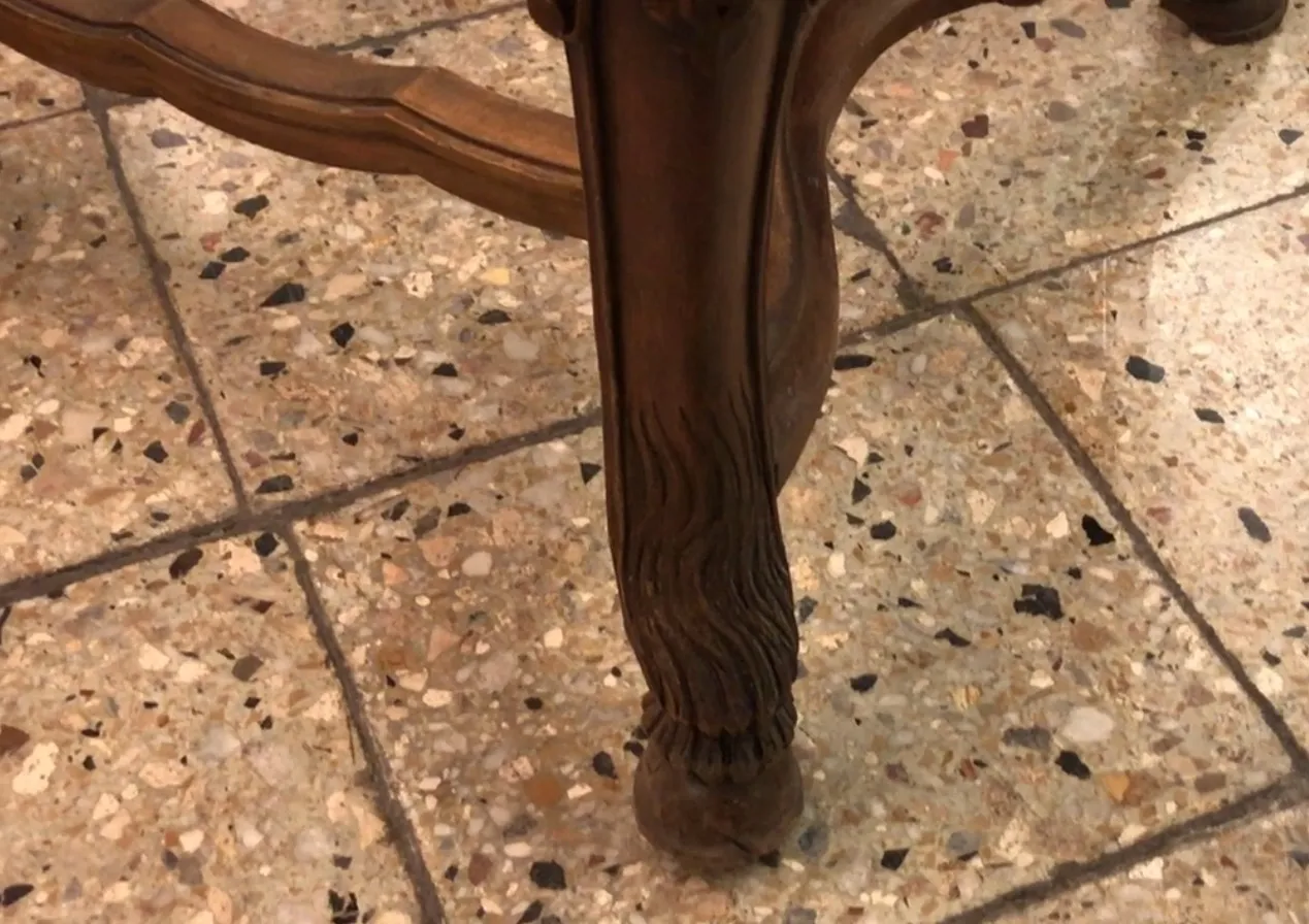 Two antique chairs with decorative legs in a classic setting