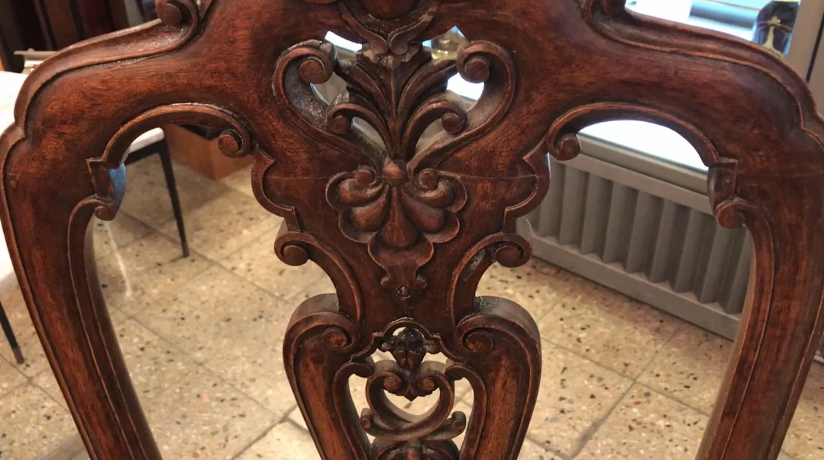 Two antique chairs with intricate details to restore.
