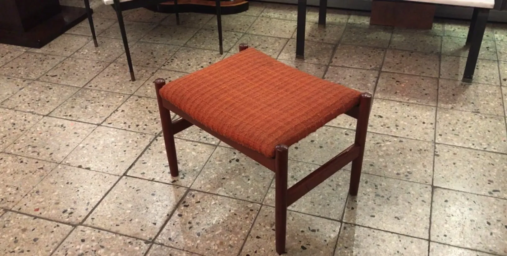 Antique stool with orange fabric seat