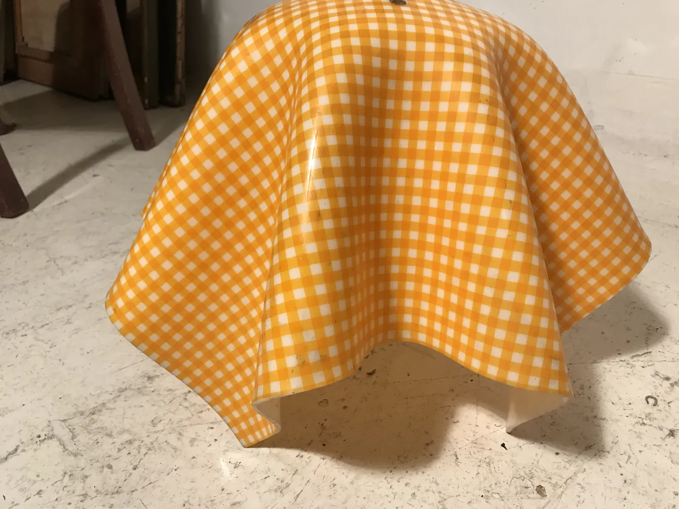 Antique hanging lamp with yellow checkered design, decorative.