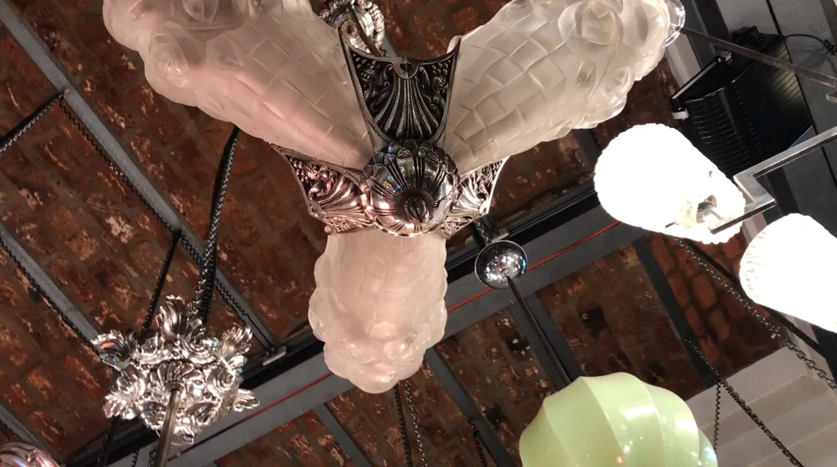 antique hanging lamp degue with frosted glass and ornamental details in a rustic setting