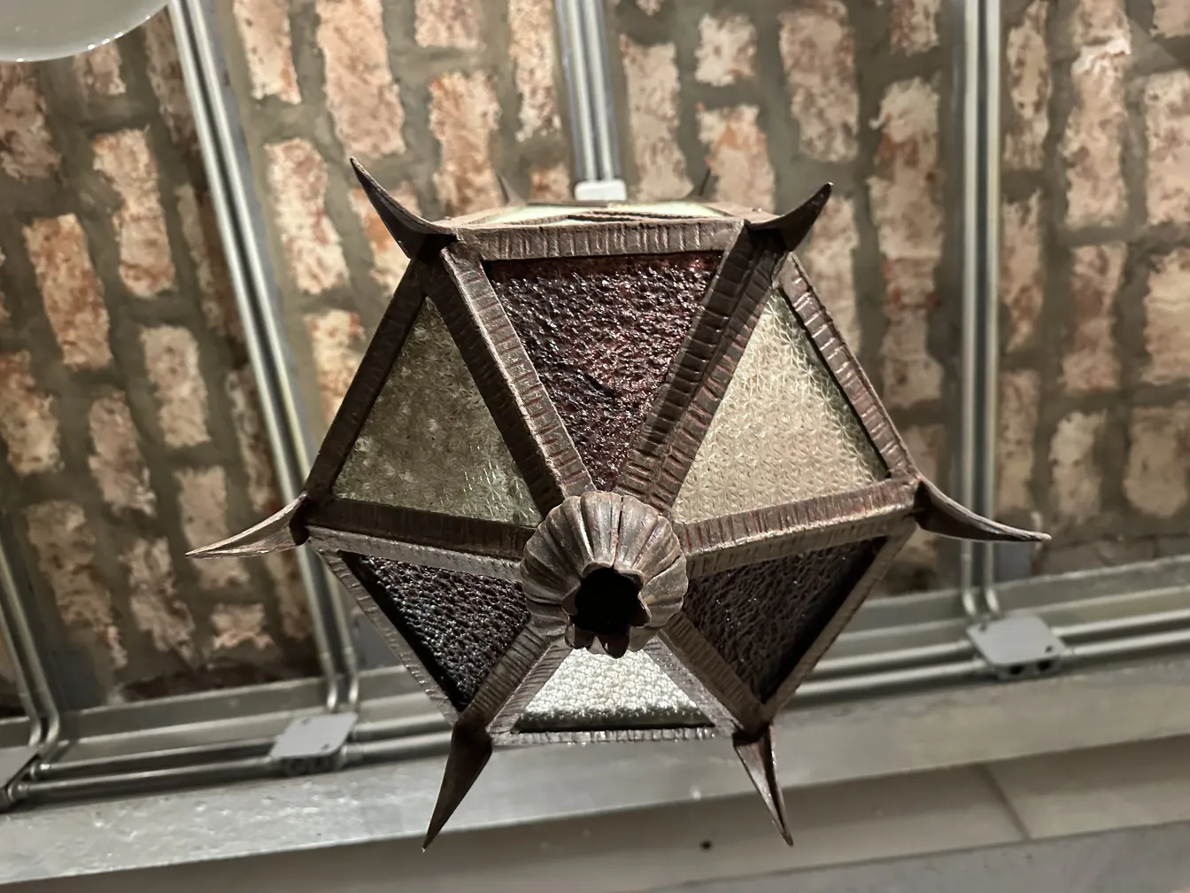 farol antiguo con paneles de vidrio en tonos marrón