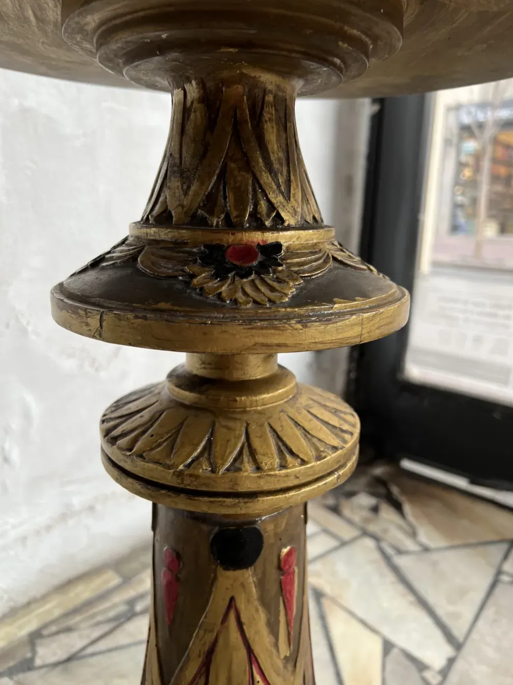 Antique sculpture adorned with colorful details, classic environment.