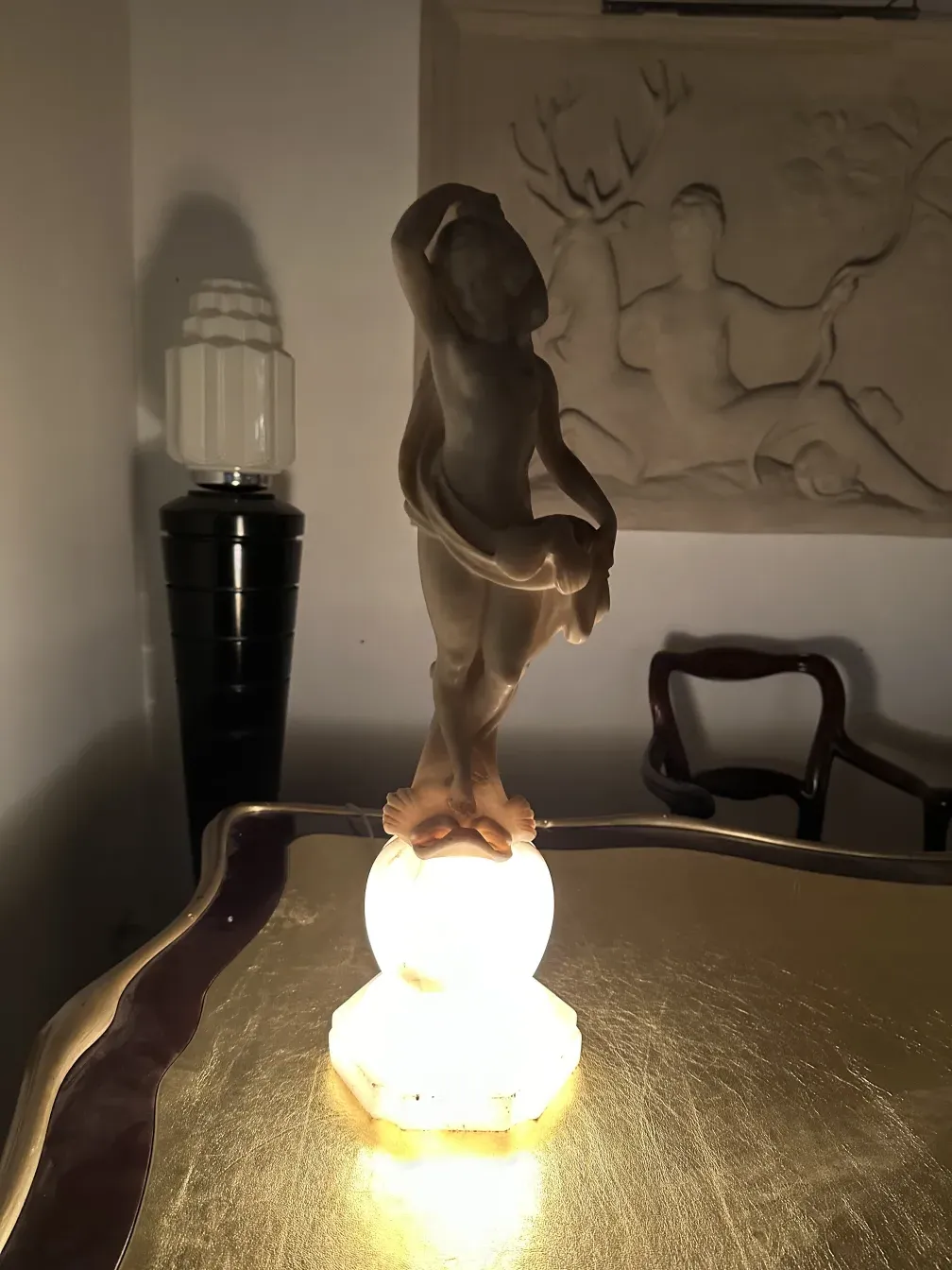 antique figurative sculpture on a lit table