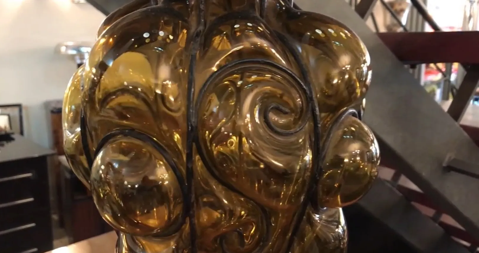 antique lantern with wavy amber design, set in an antique shop