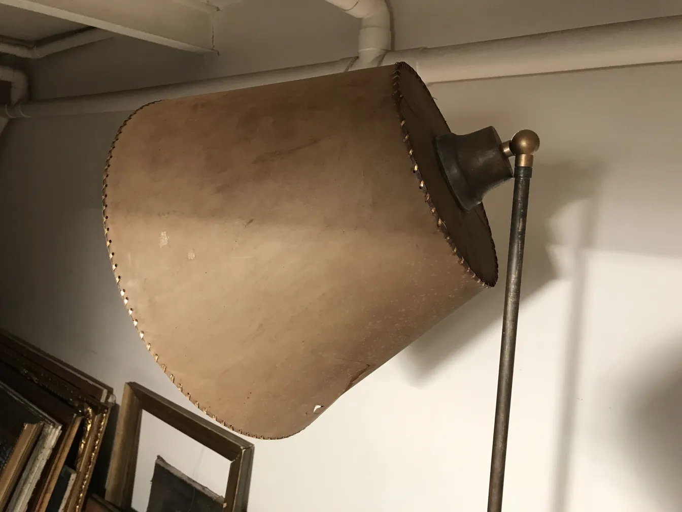 Lampada da terra antica Art Deco con paralume beige e decorazioni sottili.