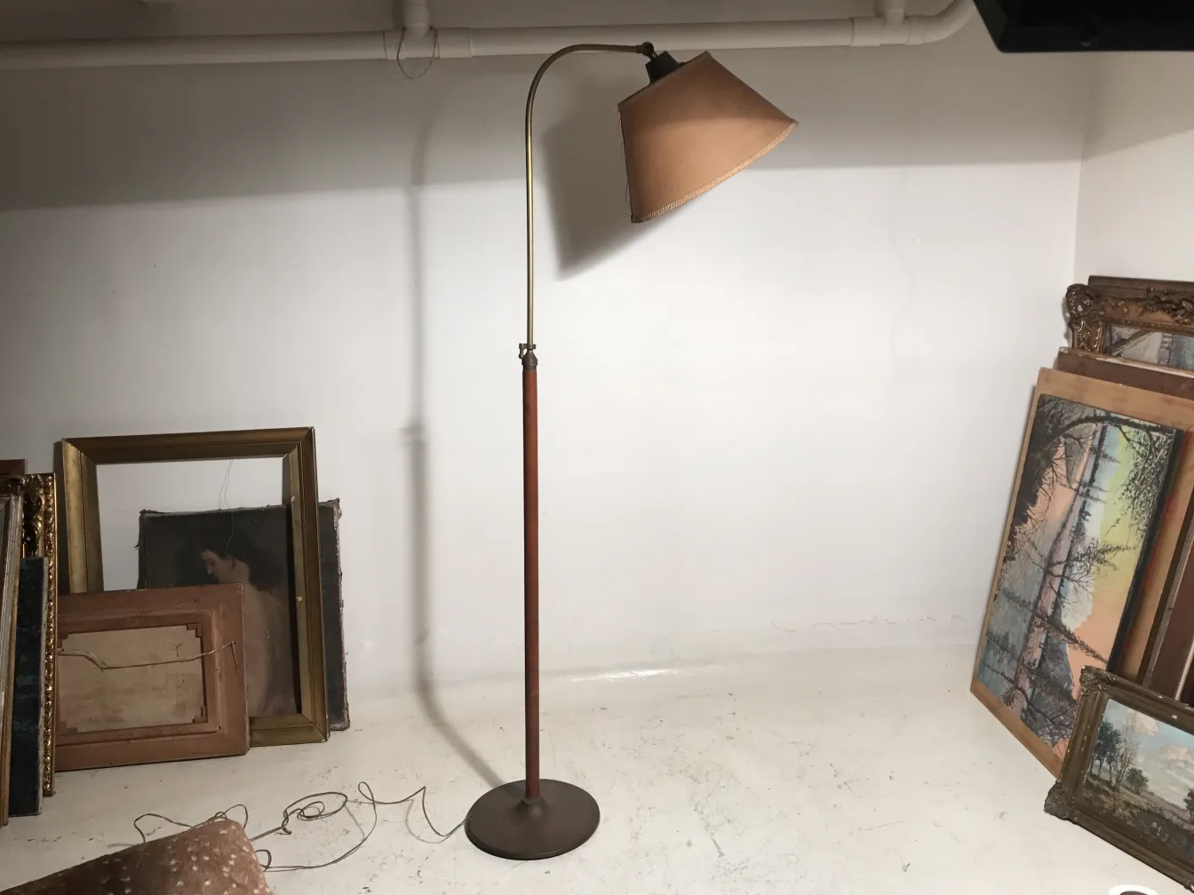 Antique floor lamp in room with paintings