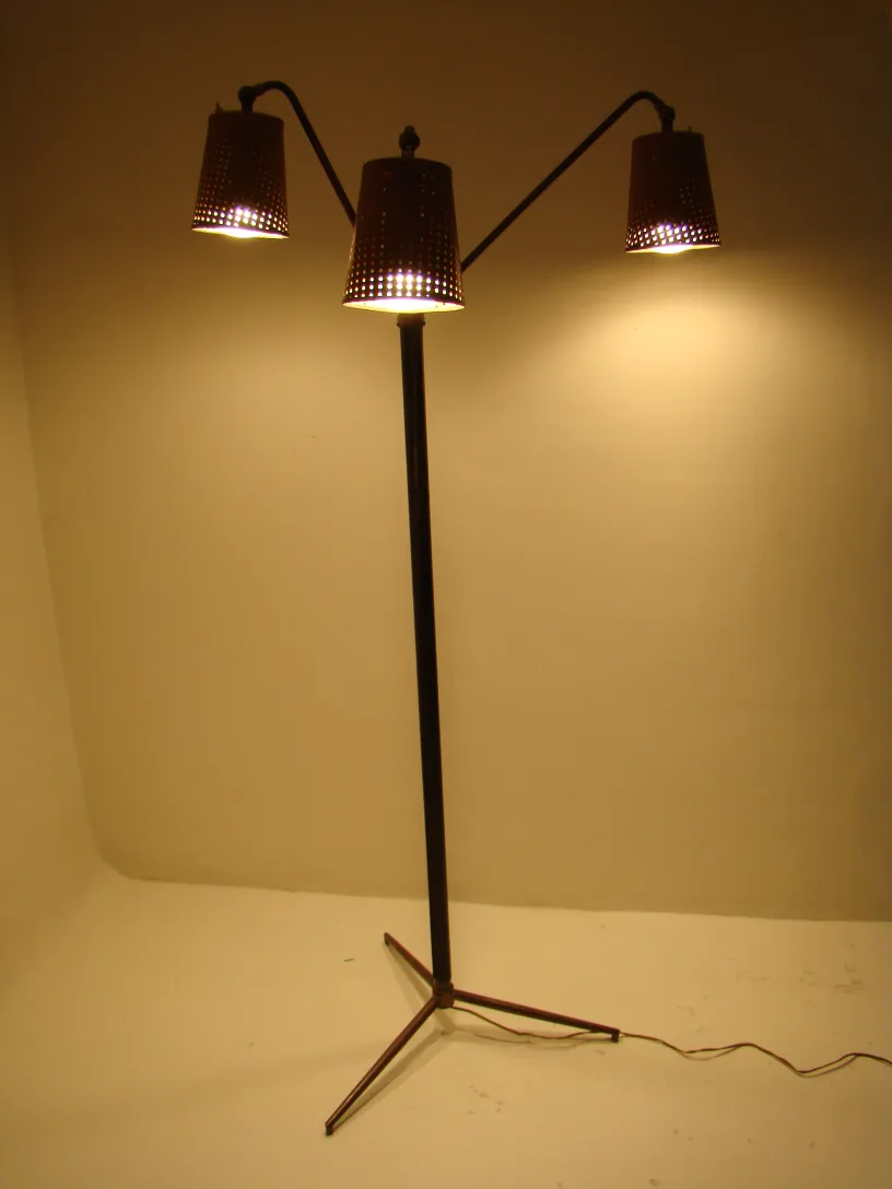 Antique Art Deco floor lamp with three light fixtures in a lit room