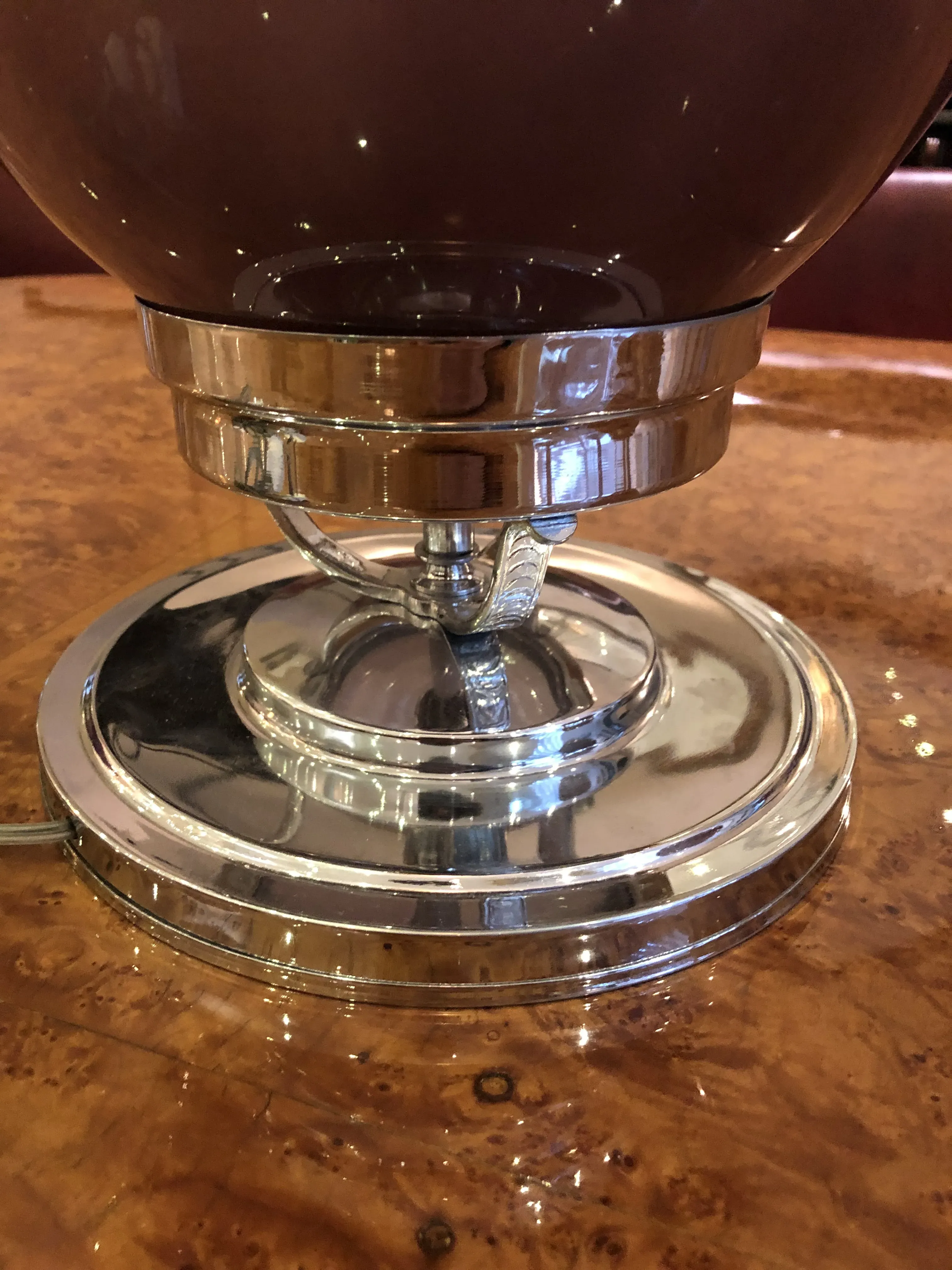 Details of 2 antique table lamps with shiny finish and polished base