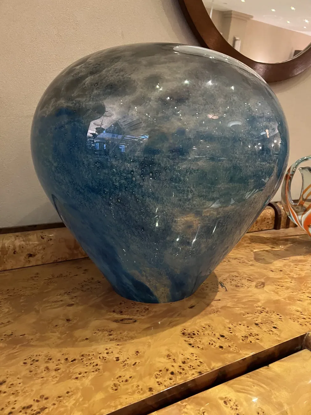 Antique table lamp with blue optics in a modern setting.