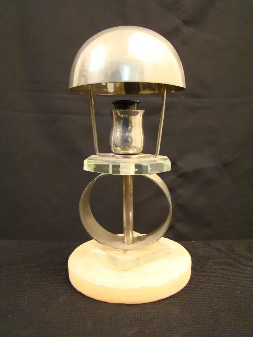 Antique table lamp in art deco style with a clear base.