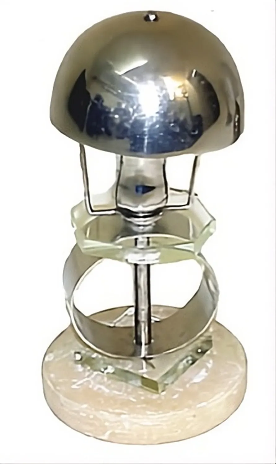 Antique table lamp in art deco style with a circular base and shiny metal dome, against a white background.