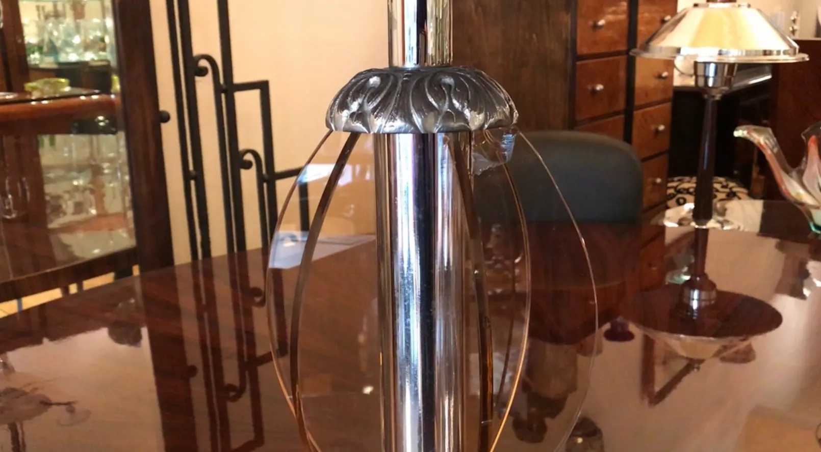 Antique table lamp in art deco style with elegant base in a classic setting.