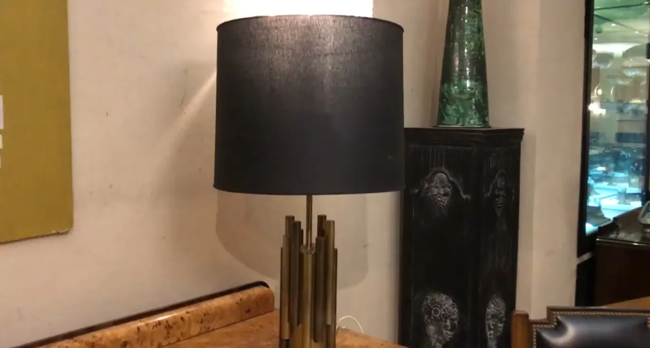 Antique table lamp with black shade in elegant setting