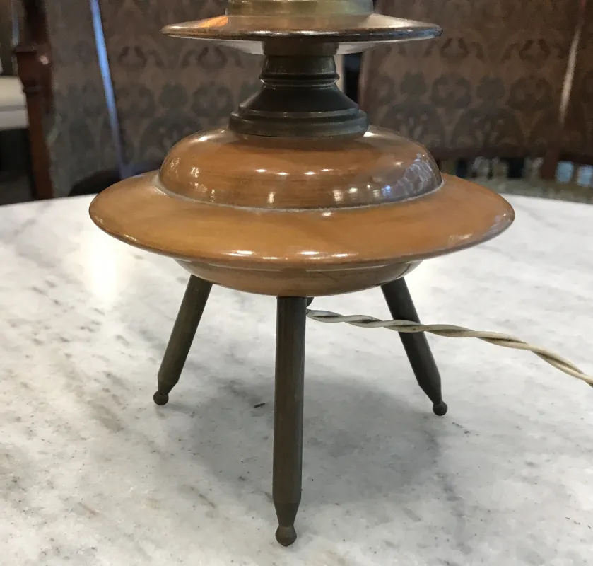 antique table lamp with three-legged base and brass tones, art deco style