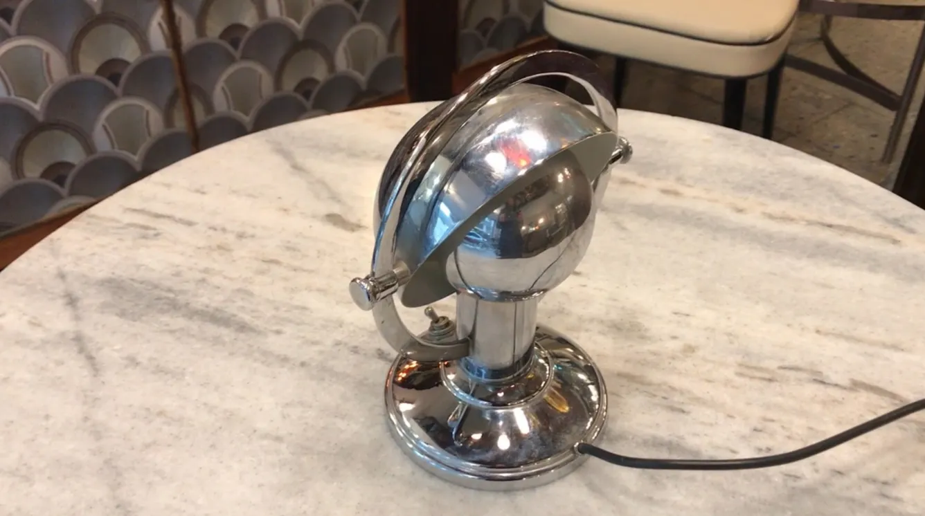 antique art deco table lamp with shiny finish on marble table