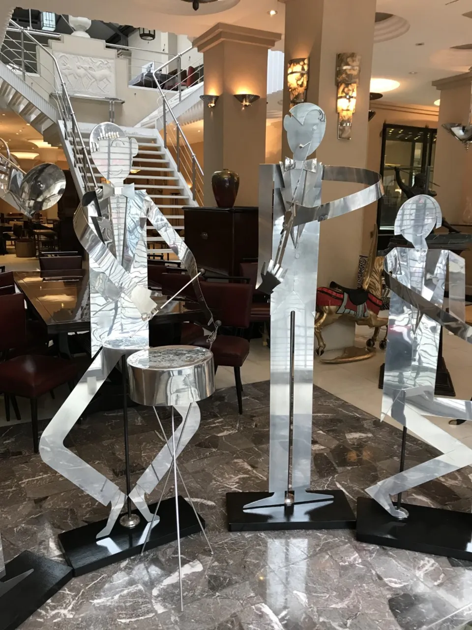 metal sculptures of musicians in a band, designed by marcelo pena, in an elegant setting