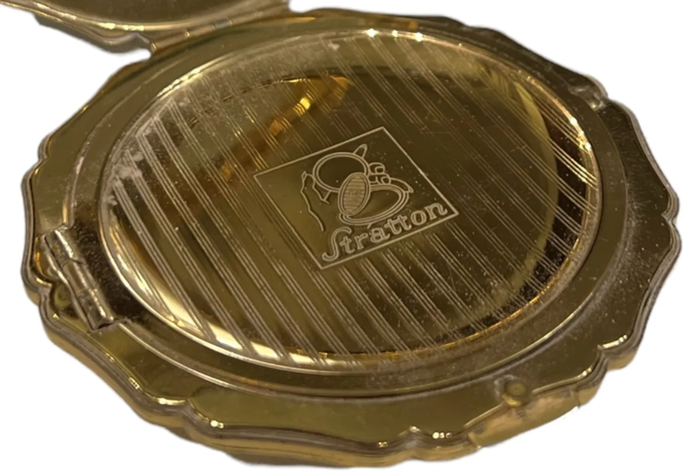 antique compact with elegant design and logo