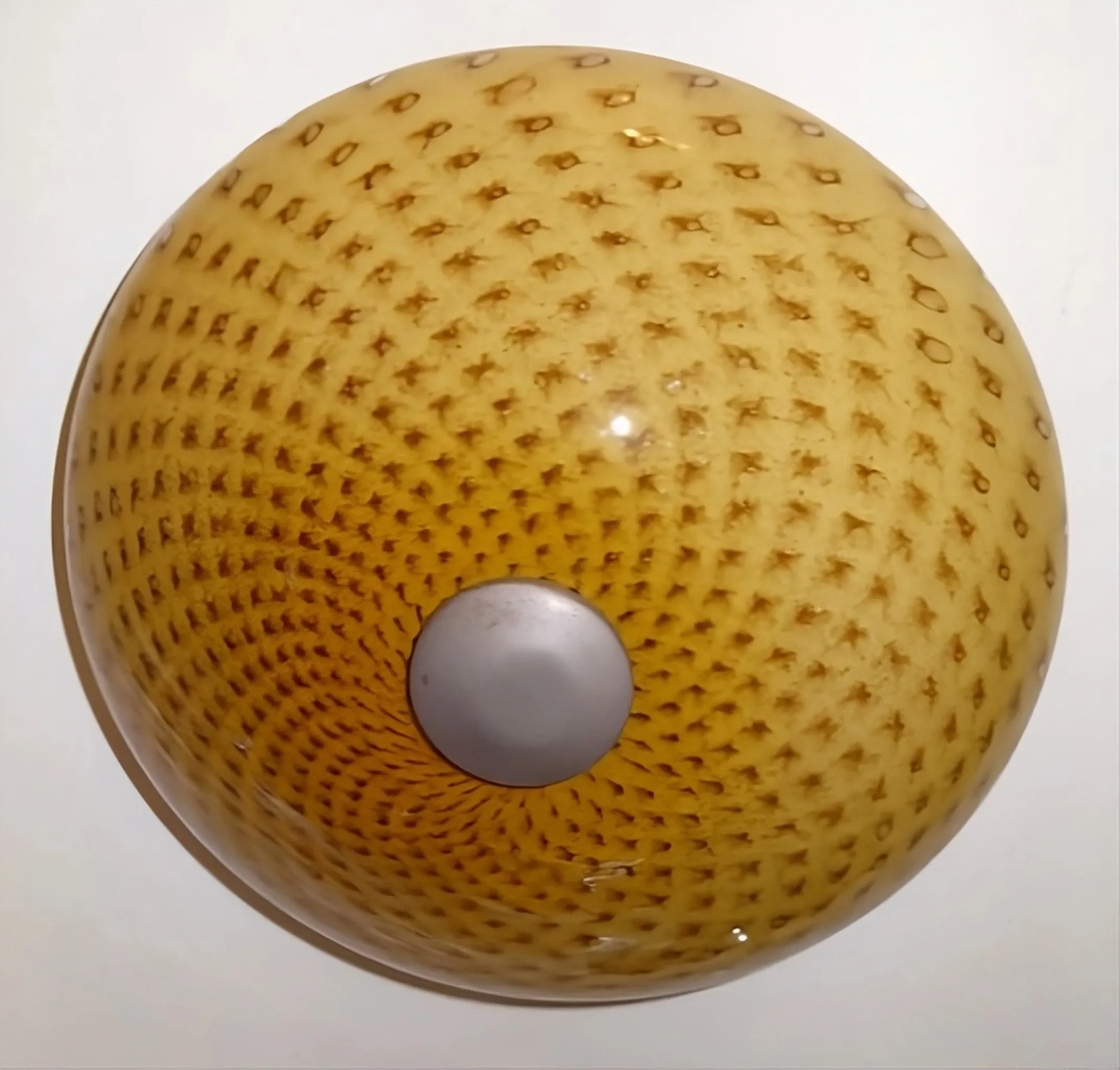 antique ceiling light with textured design in warm colors