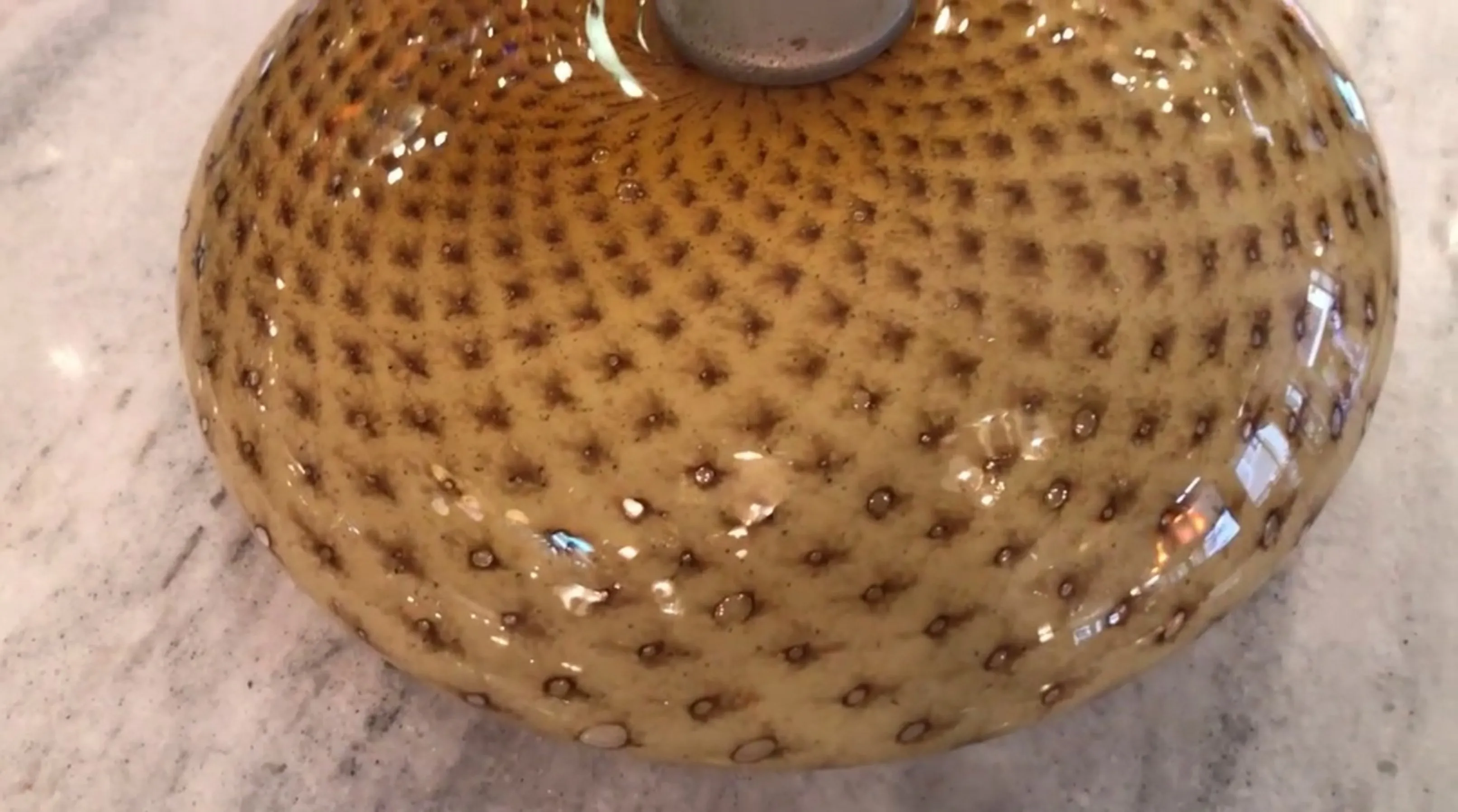 antique ceiling light with warm textured patterns