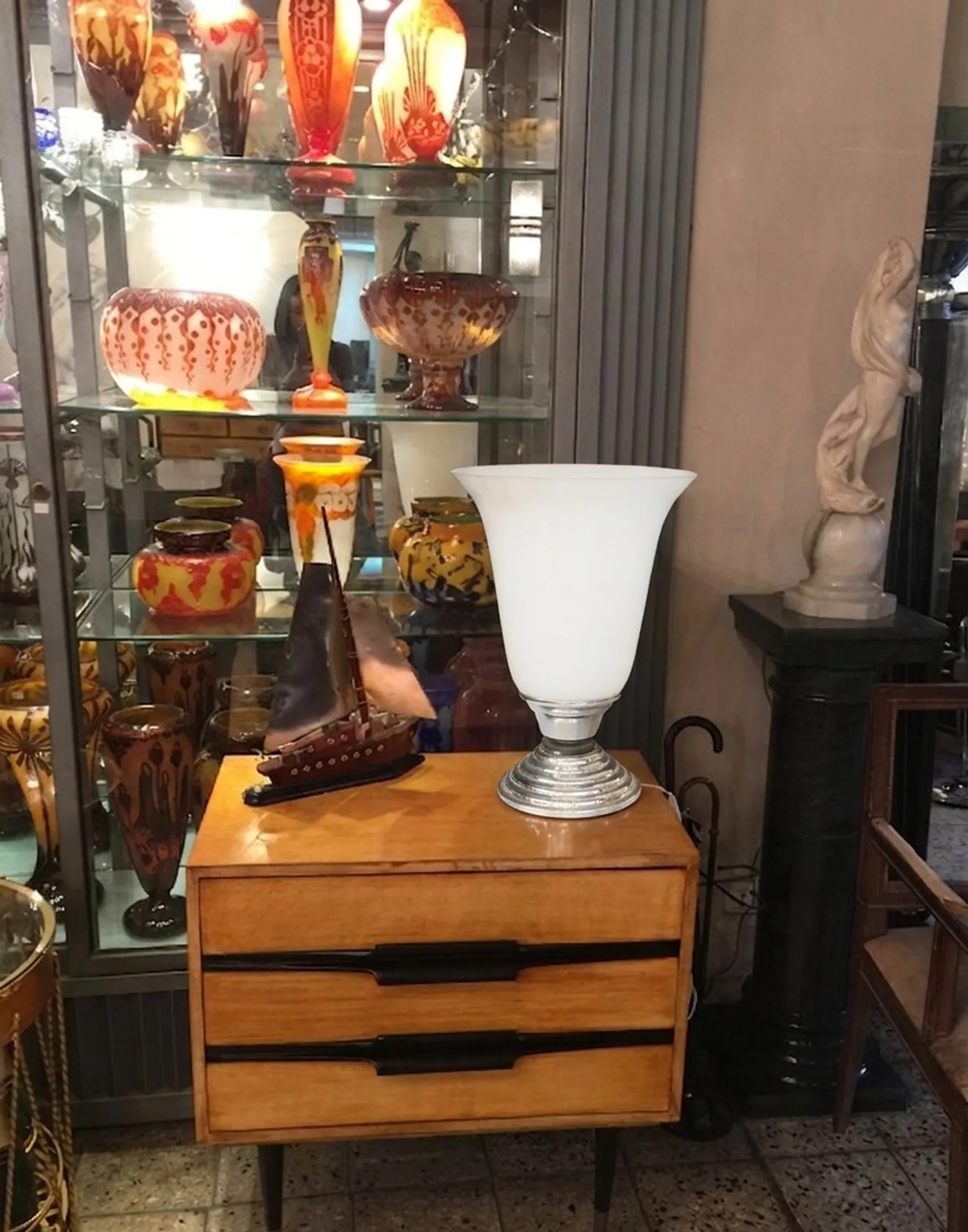 antique table lamp in white next to a vintage dresser, colorful decor