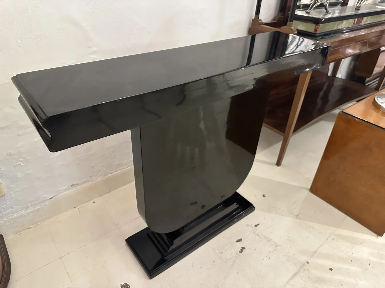 two antique art deco consoles in dark colors in an elegant setting