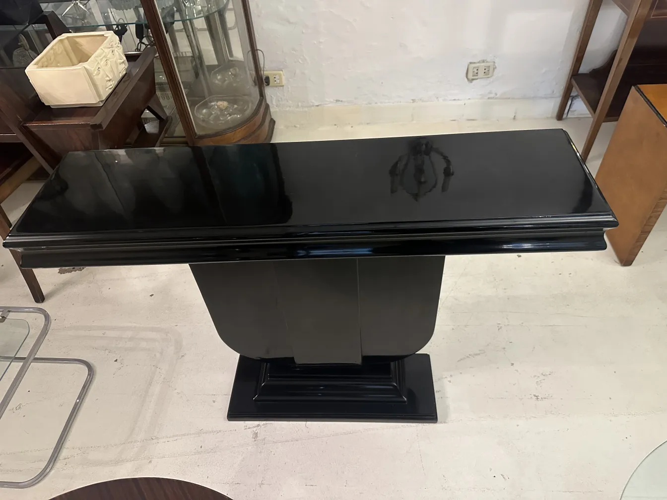Two antique consoles in Art Deco style displayed in an antique shop.