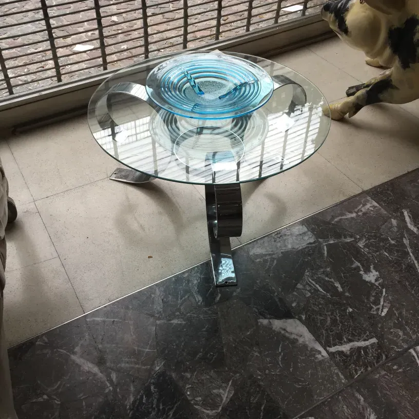 antique coffee table with circular design and shiny base, in a modern room