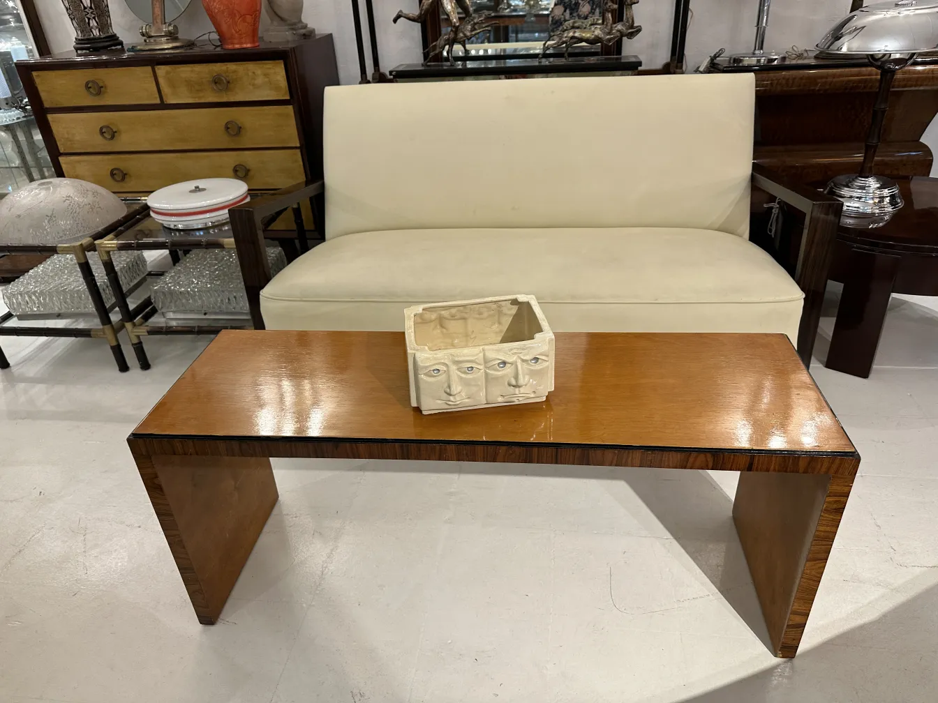 antique coffee table rectangular shape in an elegant setting next to a white sofa and decorative items
