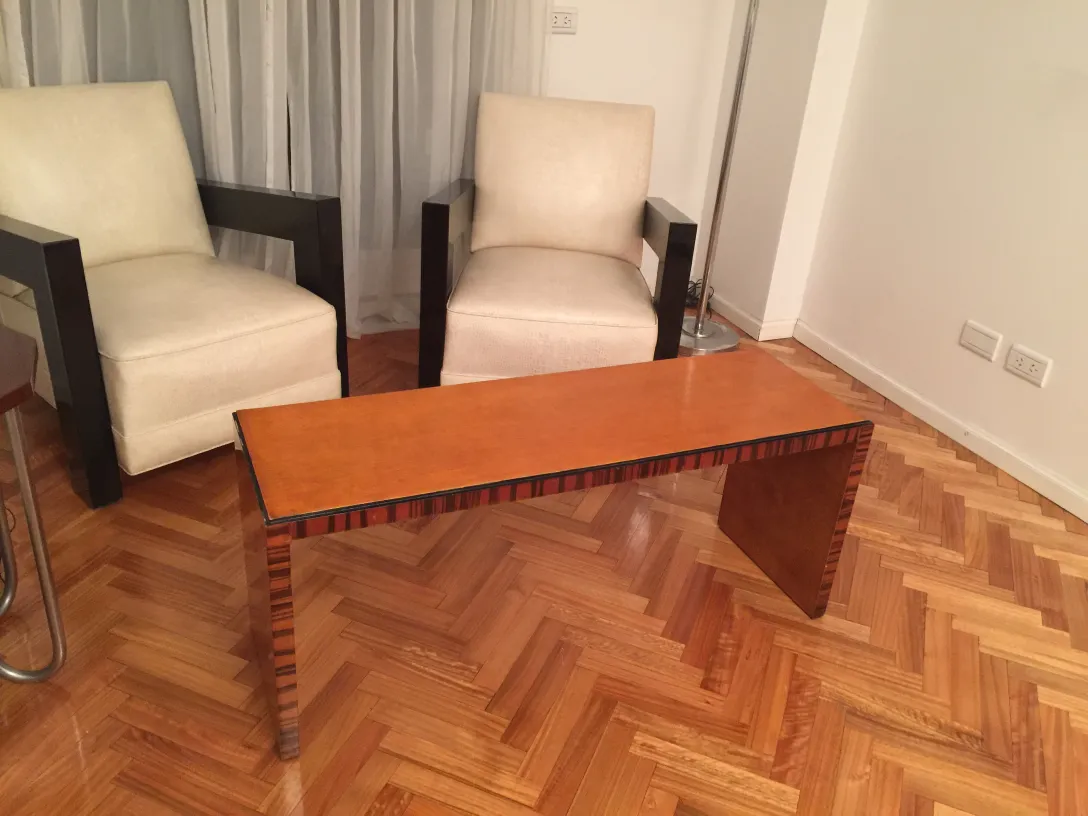 antique coffee table with elegant design, in living room with chairs