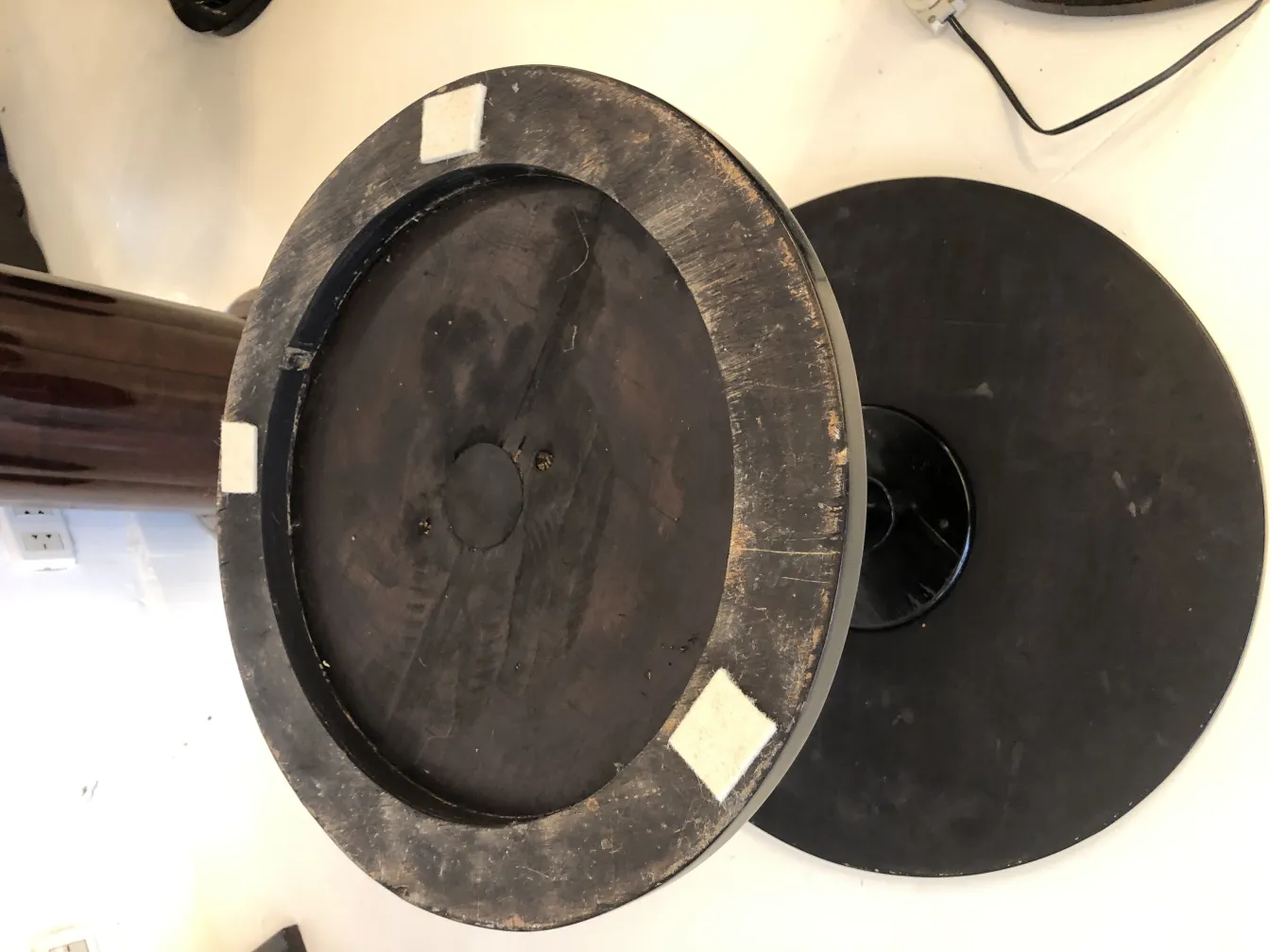 Used antique small round table with visible details and a cozy ambiance.