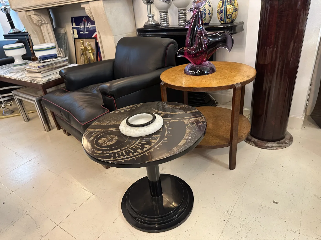 antique black small table with decorative design and a plate