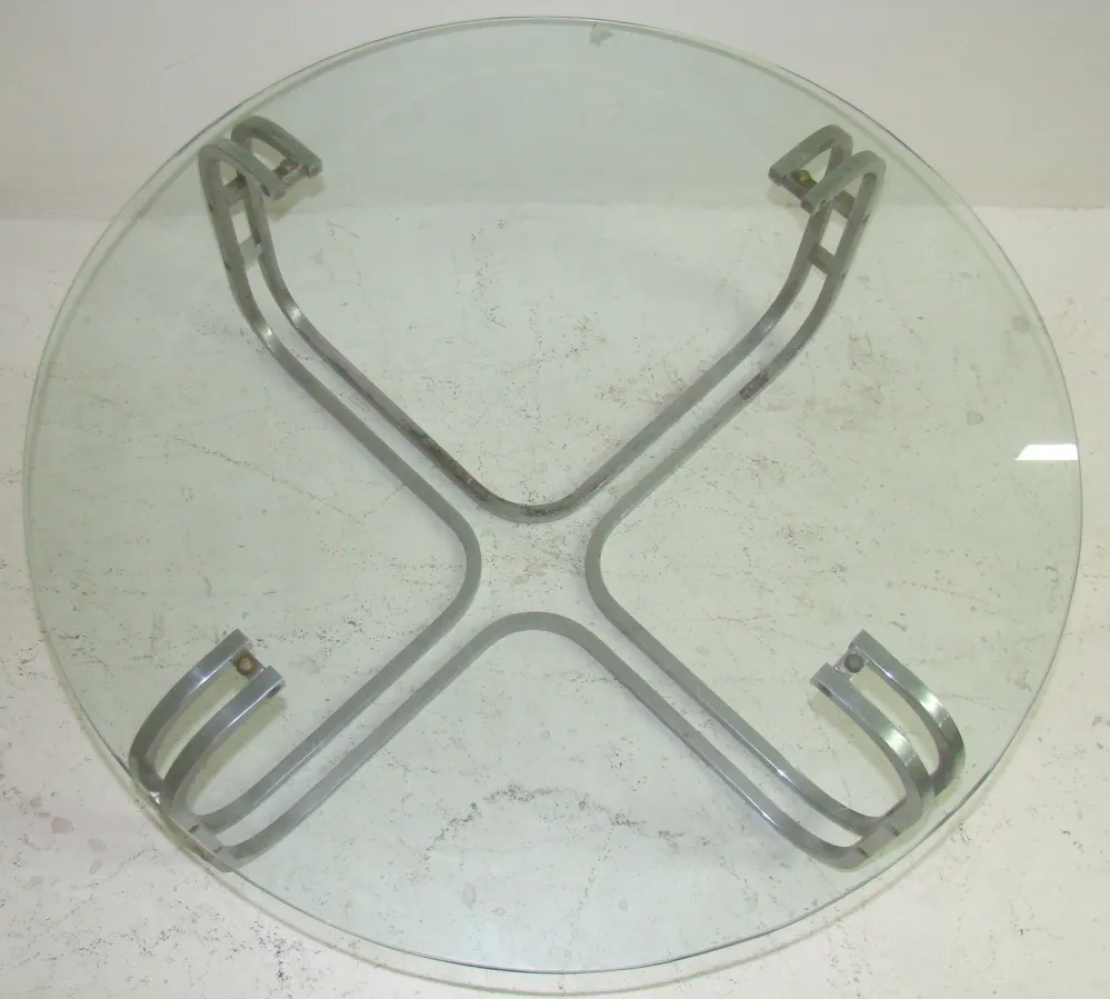 Antique art deco coffee table with a sleek metal base and round top.