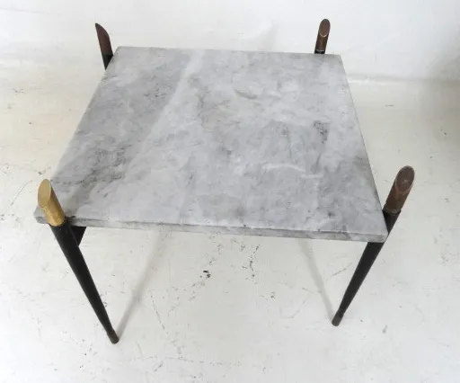 square coffee table with elegant legs, set in an antique home