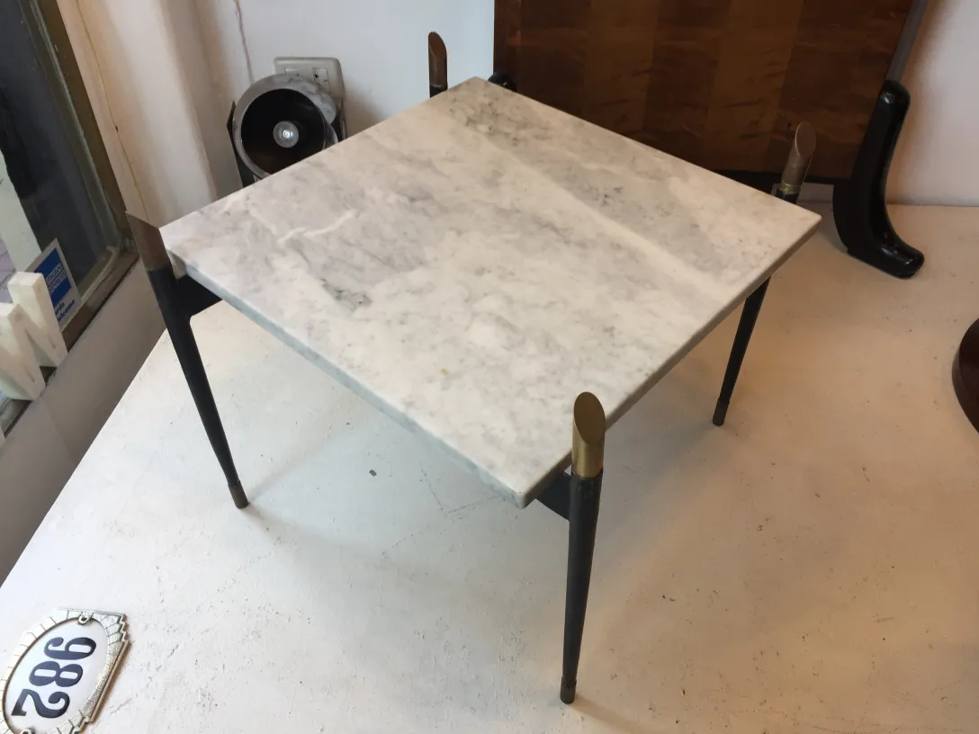 antique coffee table with metal legs in a cozy setting