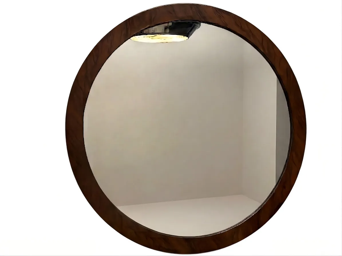 miroir rond avec un design décoratif sur le mur