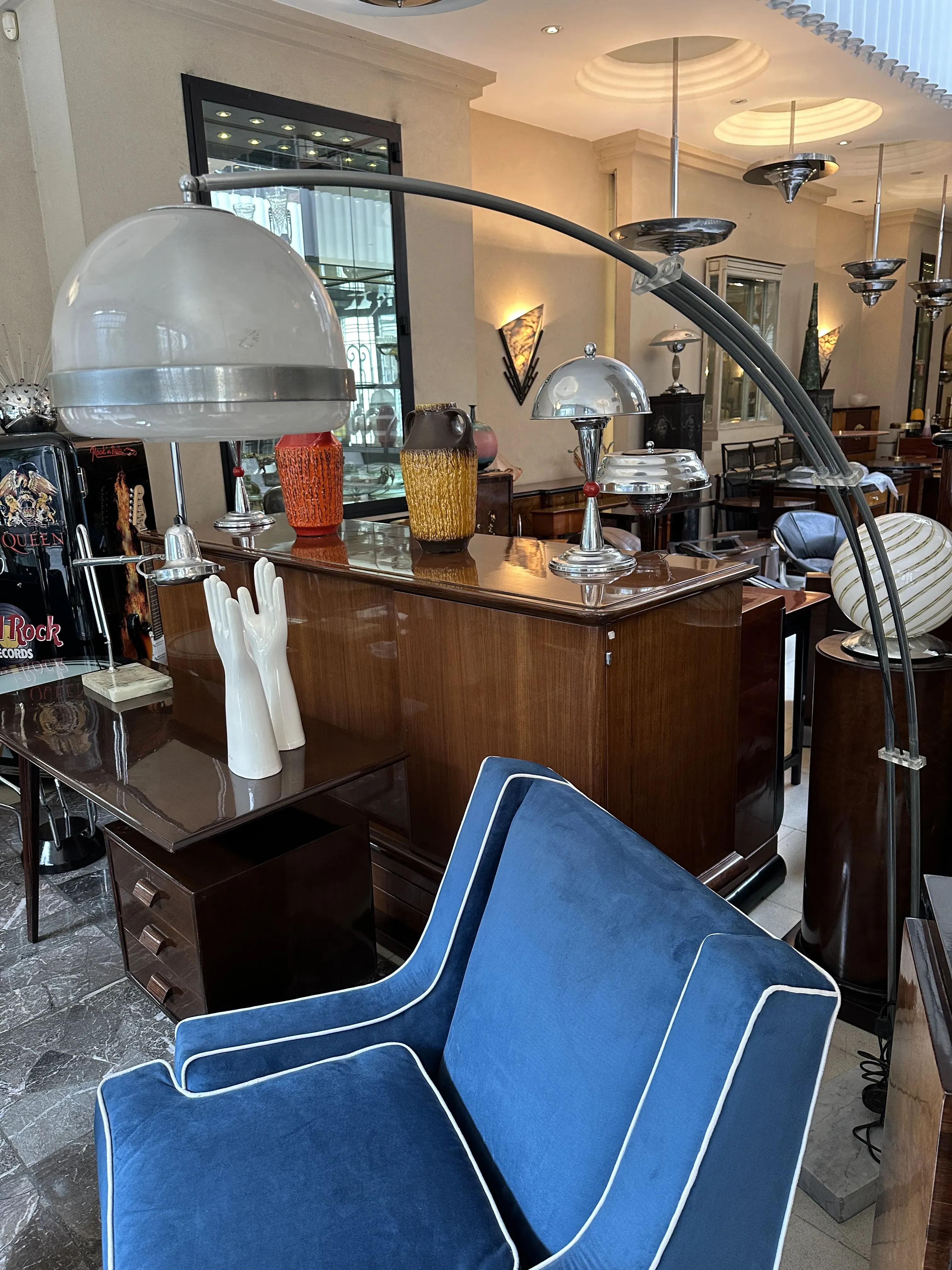 Antique floor lamp with an arch design in a stylish room with comfortable chairs.