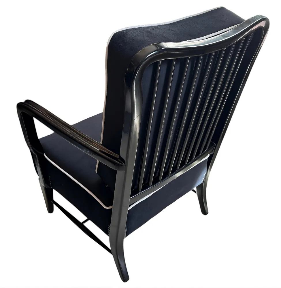 Vista posterior de 2 sillones antiguos con diseño elegante, ubicados en un ambiente acogedor