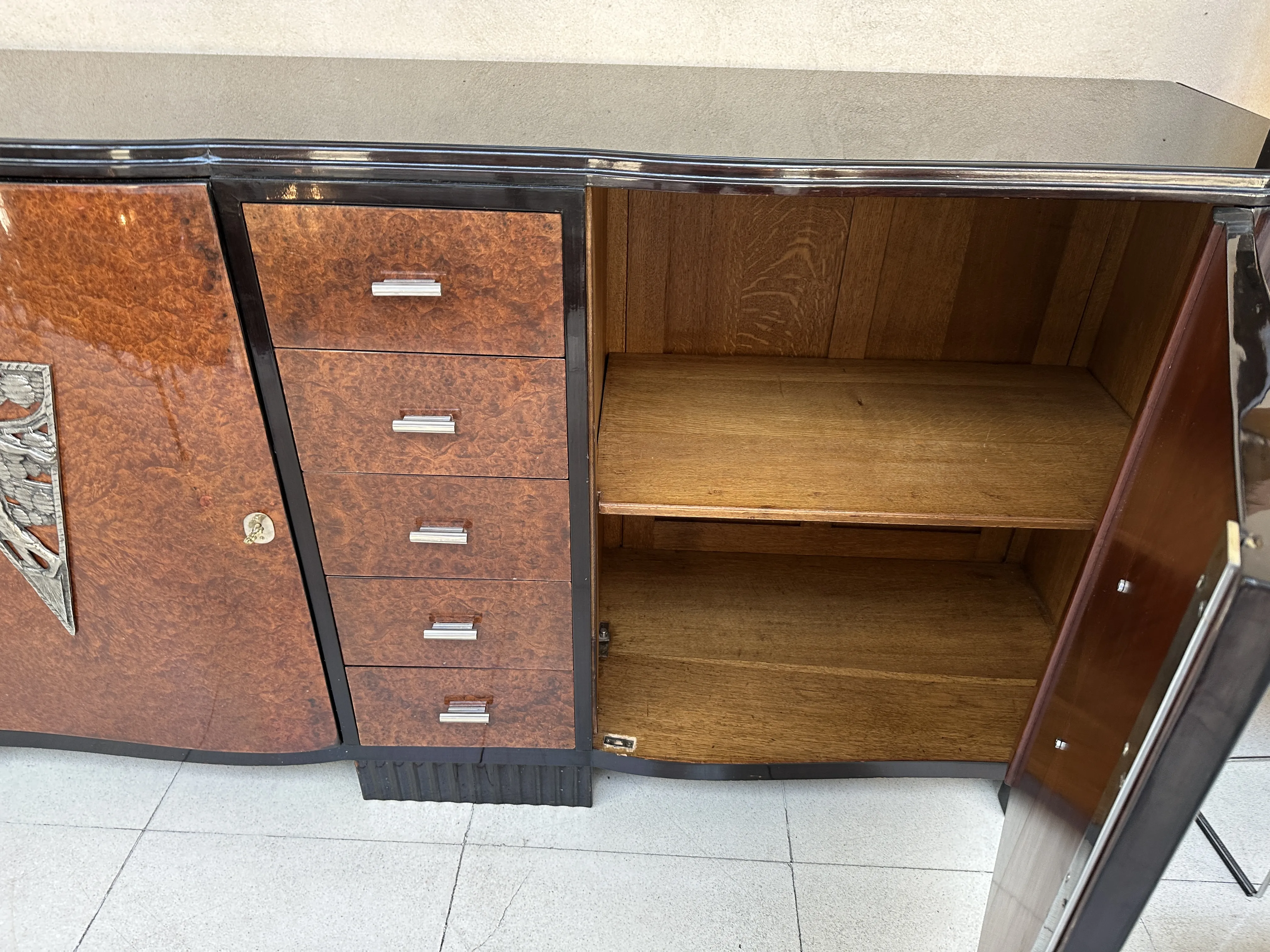 antique sideboard with visible shelves and elegantly designed doors in a neutral setting.