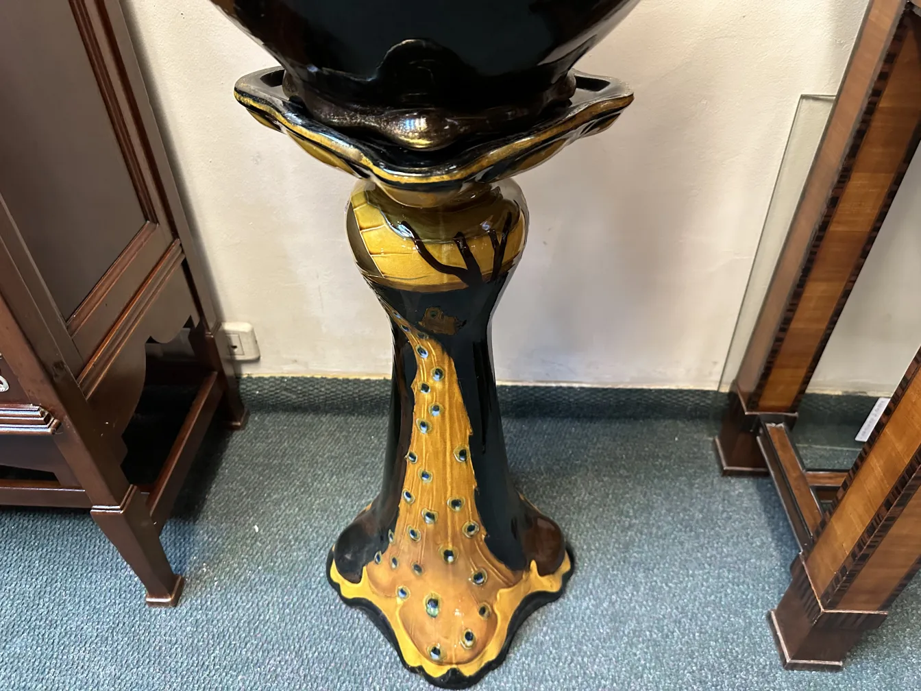 antique planter with decorative base and colorful design in an elegant setting