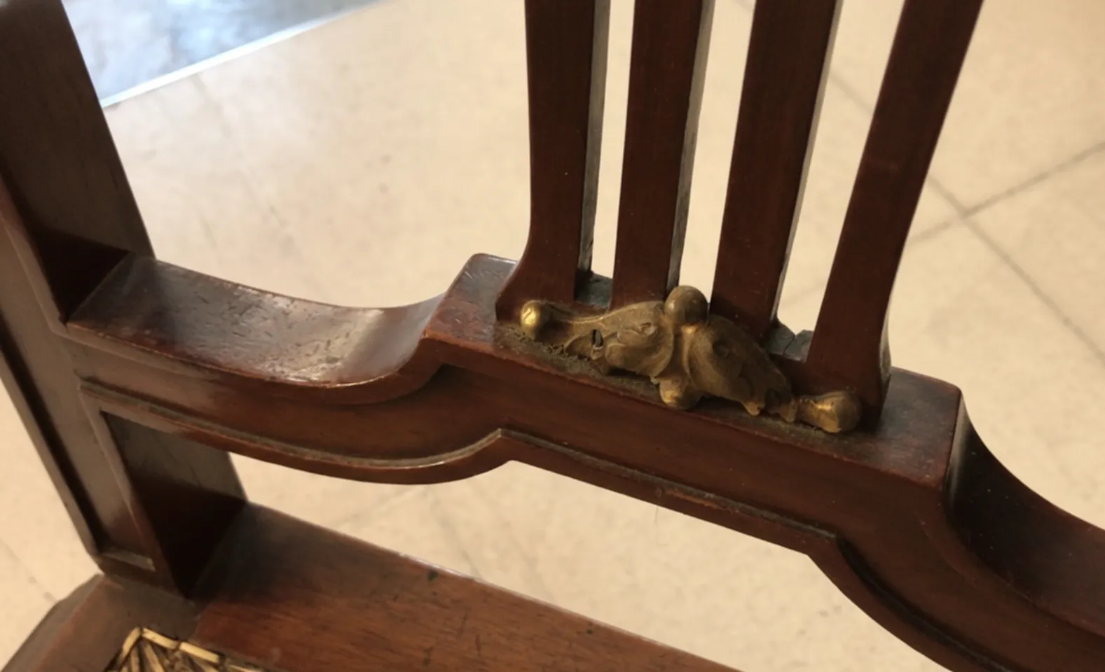 Close-up view of 2 antique chairs with intricate carvings