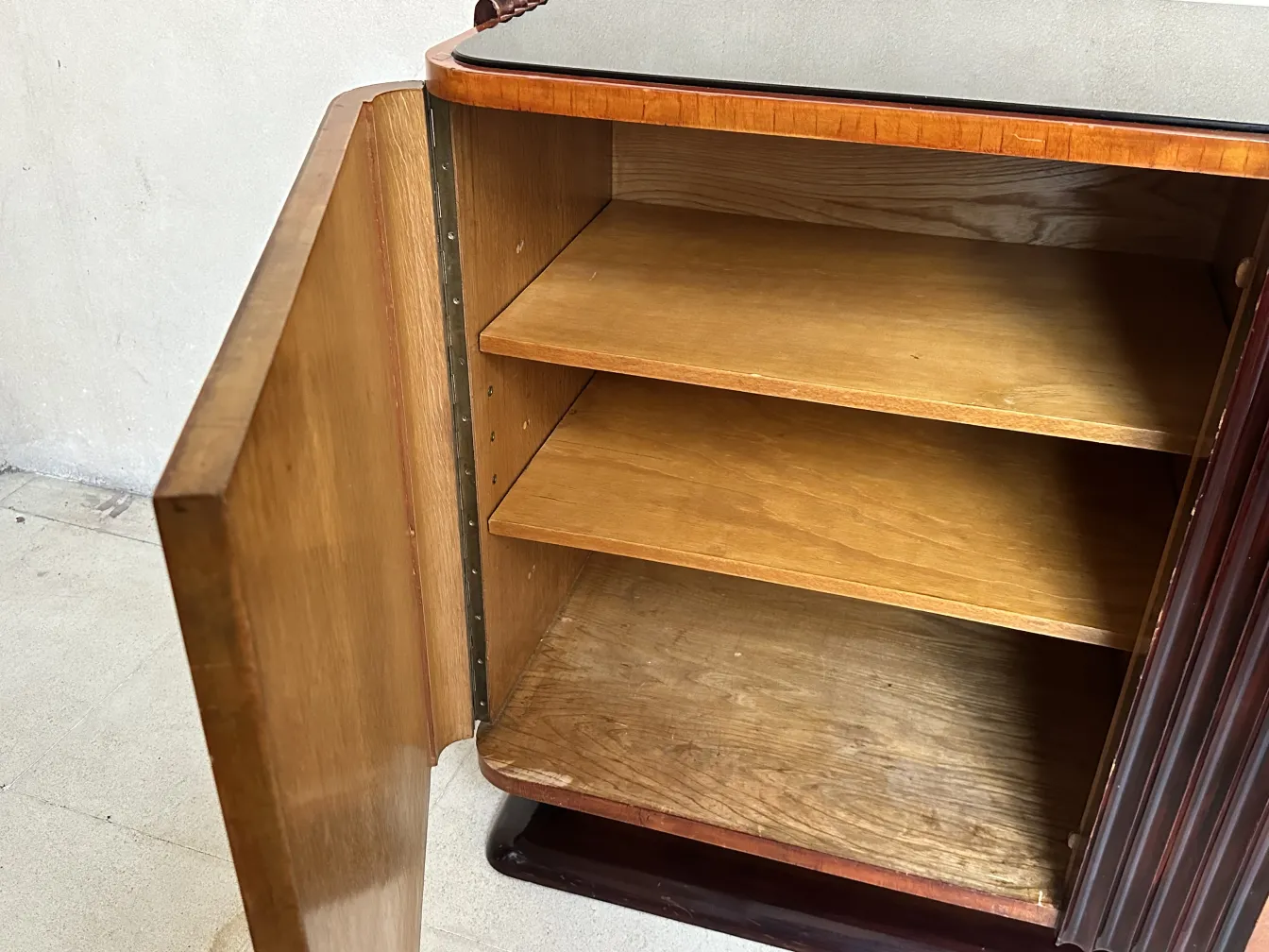 antique sideboard showing wooden shelves inside