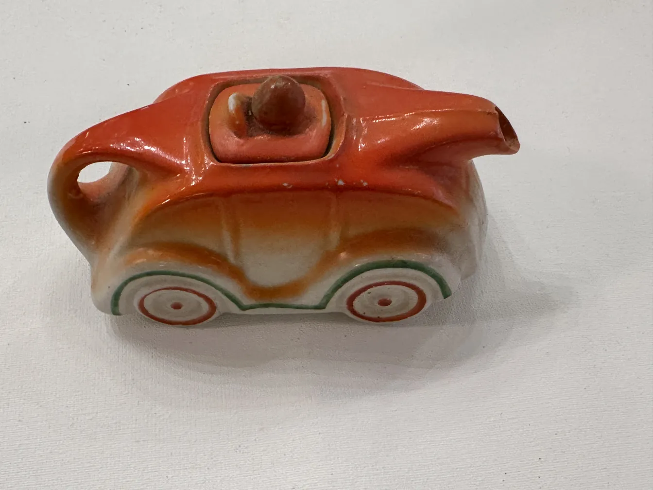 Antique ceramic with colorful design and wheel details