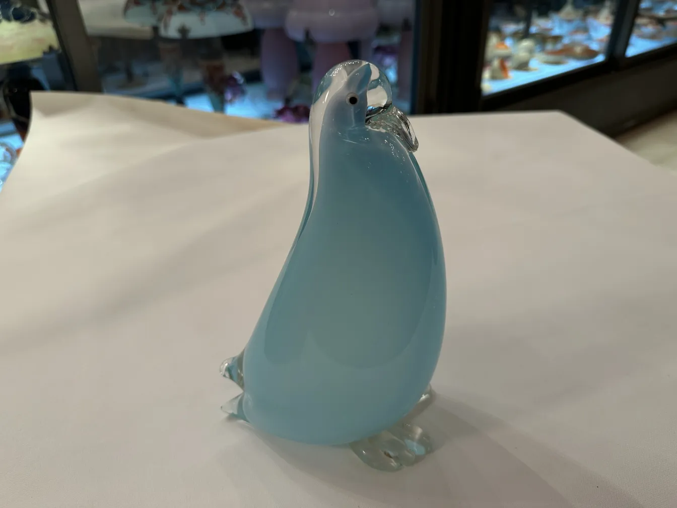 antique murano sculpture shaped like a penguin, soft colors