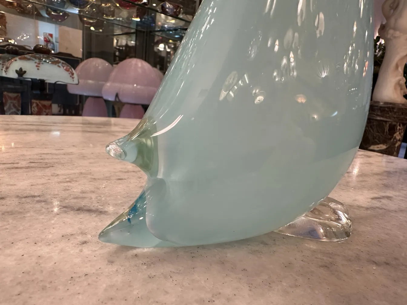 Murano sculpture depicting an animal with soft colors and a stylized shape.